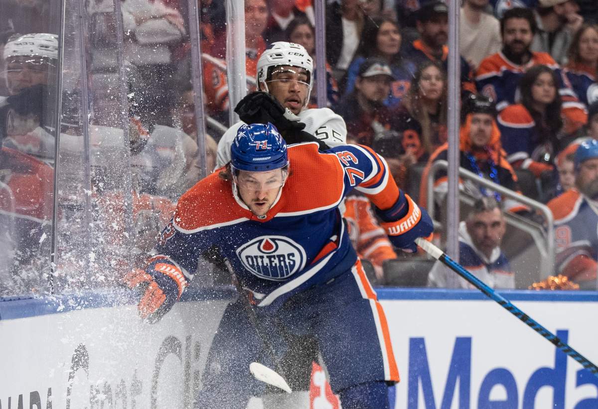 Los Angeles Kings' Quinton Byfield (55) is checked by Edmonton Oilers' Vincent Desharnais (73) during first period NHL playoff action in Edmonton on Wednesday May 1, 2024.
