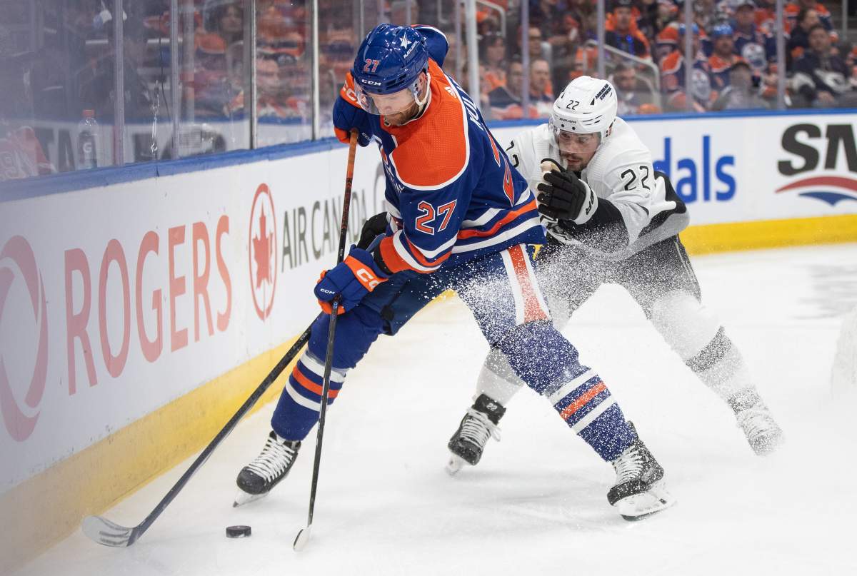 Los Angeles Kings' Kevin Fiala (22) and Edmonton Oilers' Brett Kulak (27) battle for the puck during first period NHL playoff action in Edmonton on Wednesday May 1, 2024.