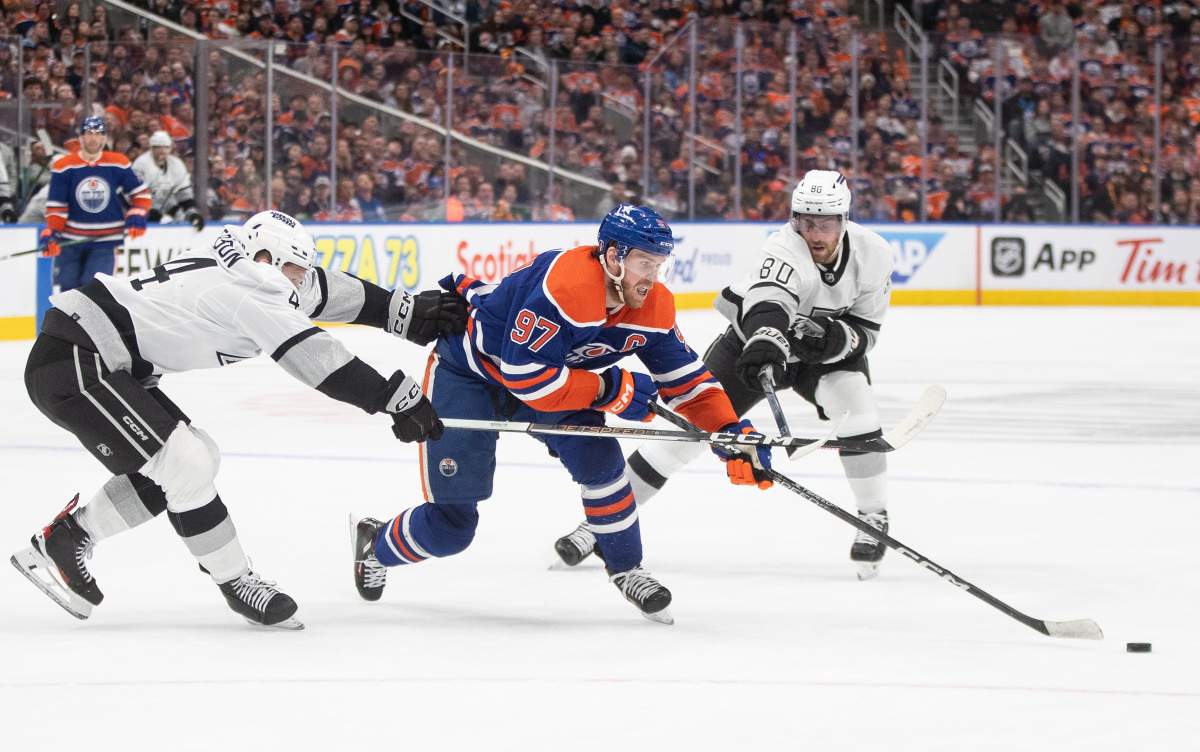 Los Angeles Kings' Mikey Anderson (44) and Pierre-Luc Dubois (80) chase Edmonton Oilers' Connor McDavid (97) during second period NHL playoff action in Edmonton on Wednesday May 1, 2024.