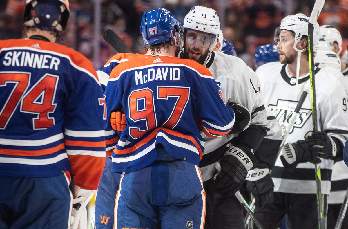 Los Angeles Kings' Anze Kopitar (11) and Edmonton Oilers' Connor McDavid (97) shake hands after the Oilers won the series four games to one during NHL playoff action in Edmonton on Wednesday May 1, 2024.