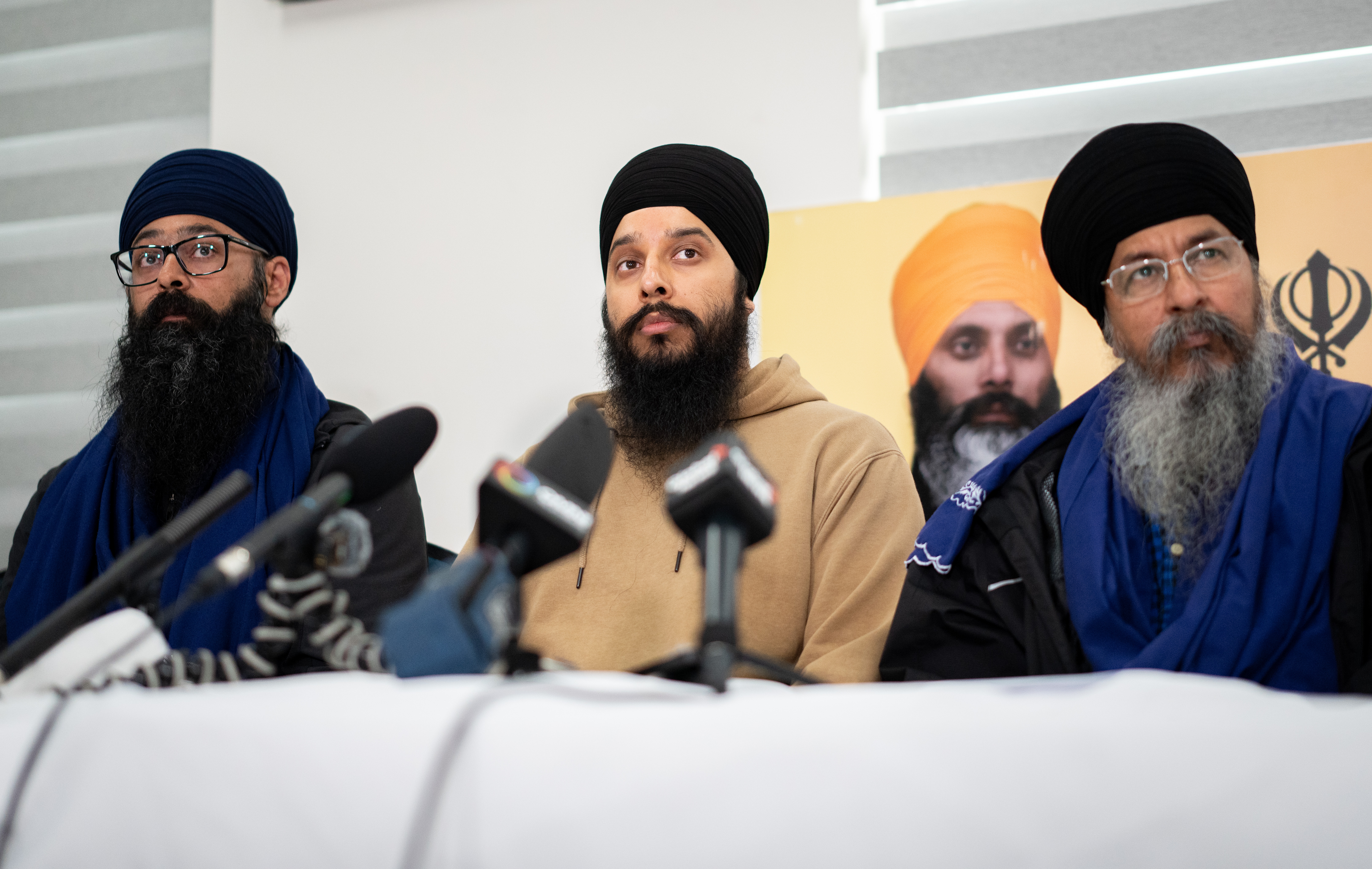 Moninder Singh, left, Brabjot Singh, centre, and Gurmeet Singh, at a news conference on Hardeep Singh Nijjar homicide, May 3, 2024. THE CANADIAN PRESS/Ethan Cairns
