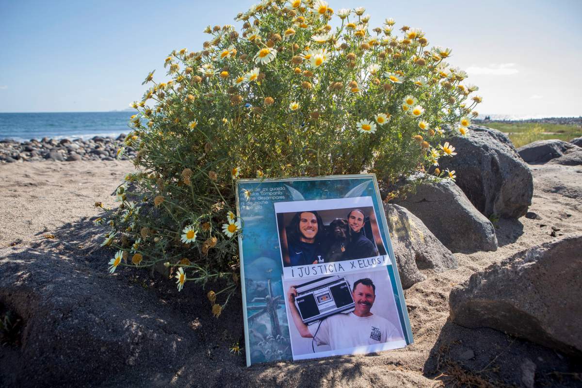 The photos of the foreign surfers who disappeared, and were later found dead, placed on the beach in Ensenada, Mexico, Sunday, May 5, 2024.