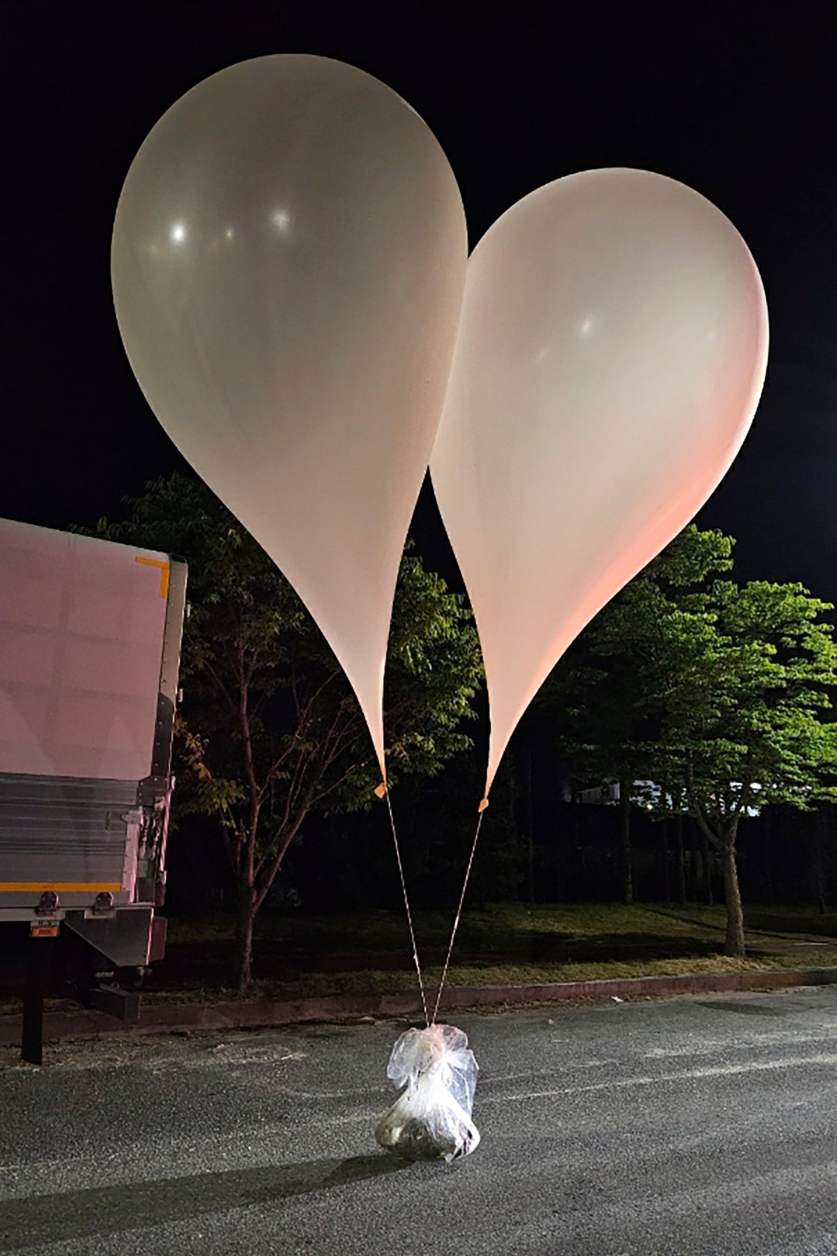 This photo provided by South Korea Defense Ministry, shows balloons with trash in South Chungcheong Province, South Korea, Wednesday, May 29, 2024.