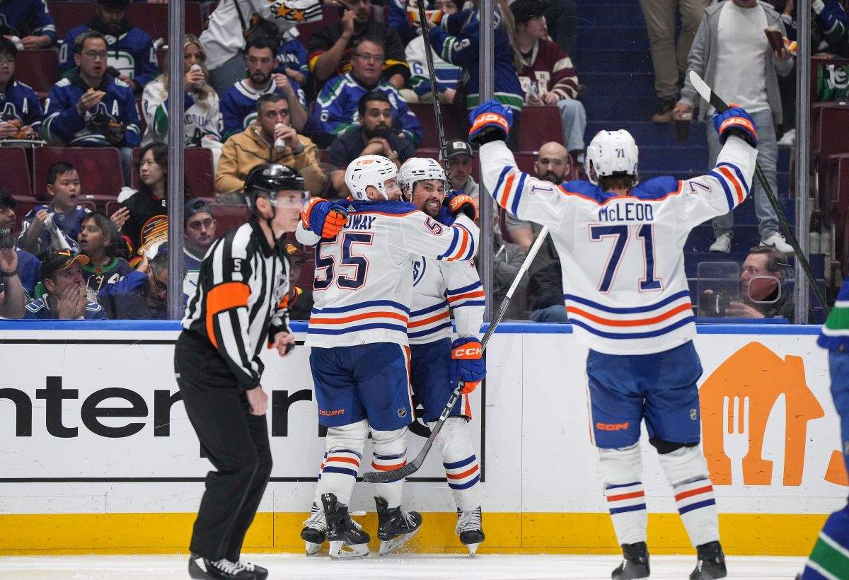 Edmonton Oilers' Dylan Holloway, back left, Cody Ceci and Ryan McLeod celebrate Ceci's goal against the Vancouver Canucks during the second period in Game 7 of an NHL hockey Stanley Cup second-round playoff series, in Vancouver, on Monday, May 20, 2024.