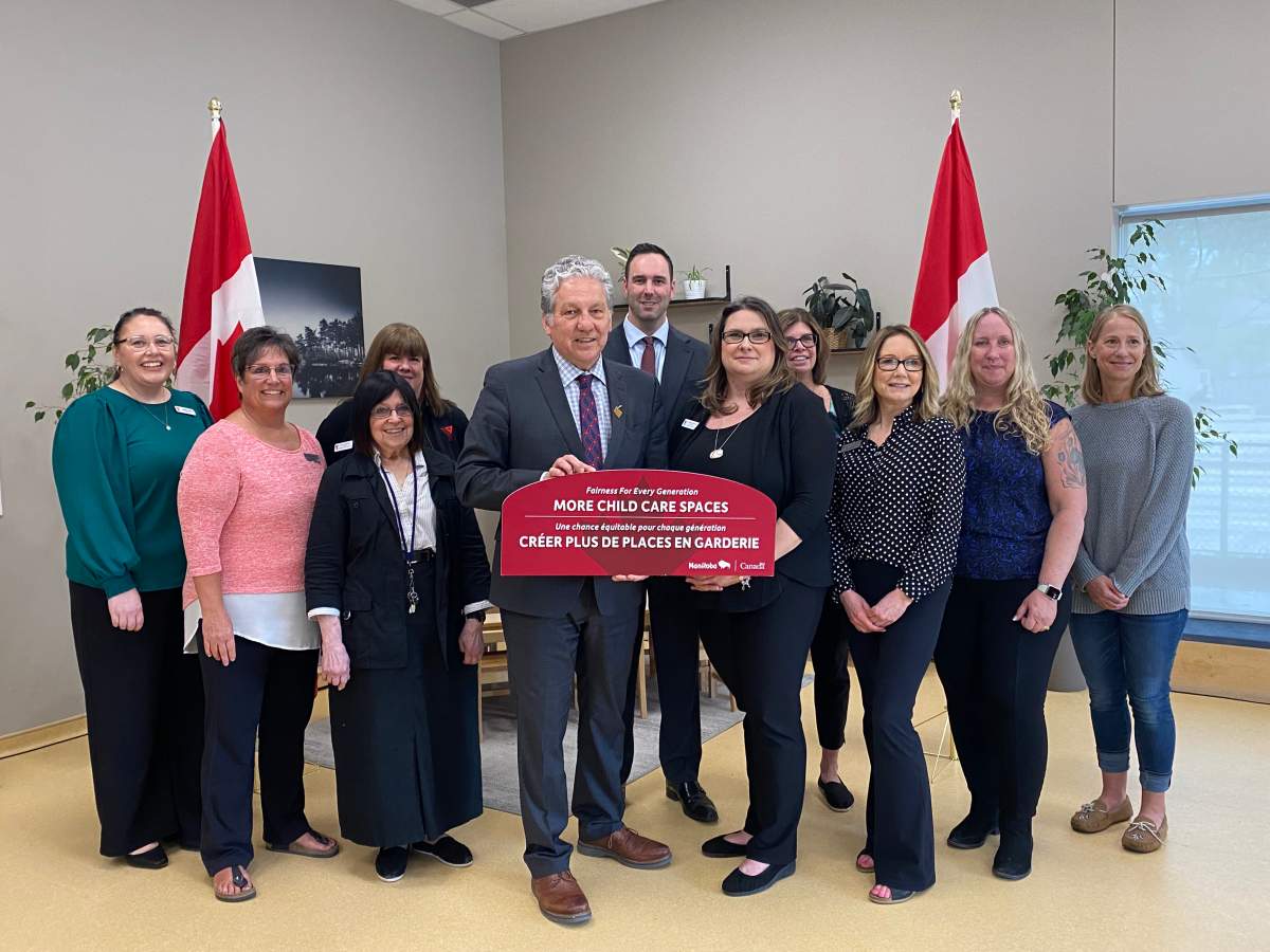 MP's Dan Vandal and Ben Carr get their photo taken with child care workers.