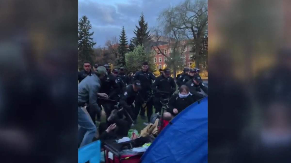 Edmonton Police Service members dismantling a pro-Palestinian protest encampment at the University of Alberta on Saturday, May 11, 2024.