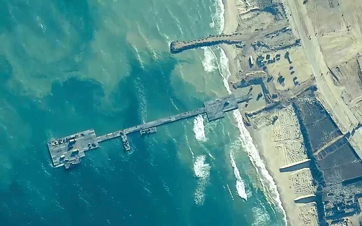 The image provided by U.S, Central Command, shows U.S. Army soldiers assigned to the 7th Transportation Brigade (Expeditionary), U.S. Navy sailors assigned to Amphibious Construction Battalion 1, and Israel Defense Forces placing the Trident Pier on the coast of Gaza Strip on Thursday, May 16, 2024.