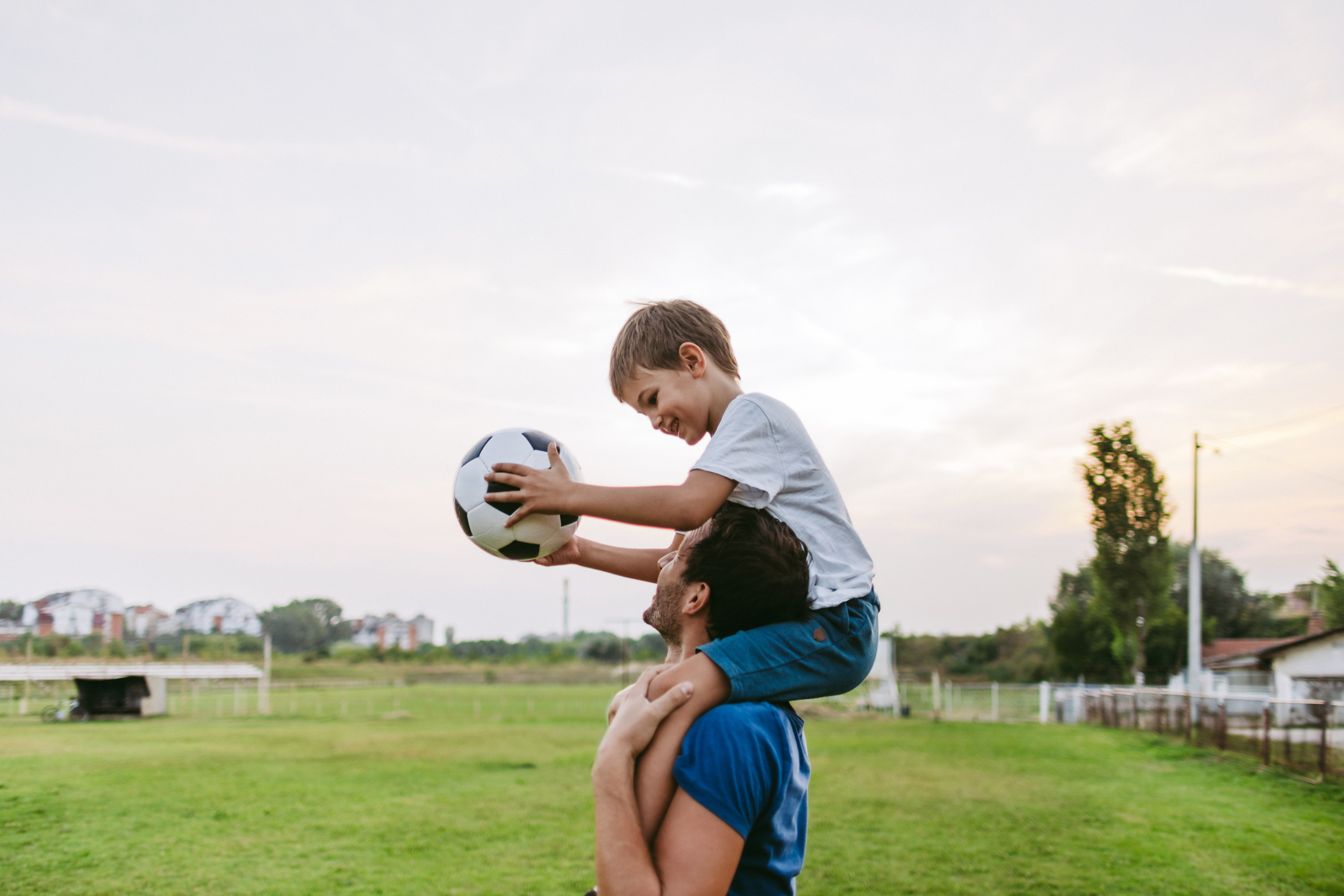Dad and kid on the soccer field