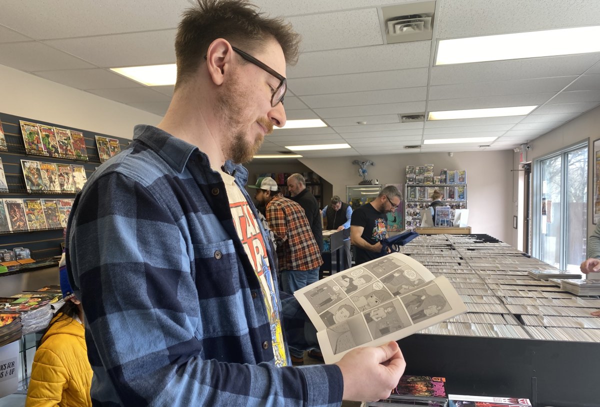 Local comic creator Nicholas Friesen flips through an issue of his comic, Olivia Sea.