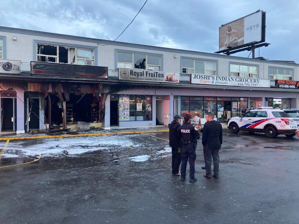 Police stand outside the scene of a commercial fire in Scarborough reported on May 3, 2024.