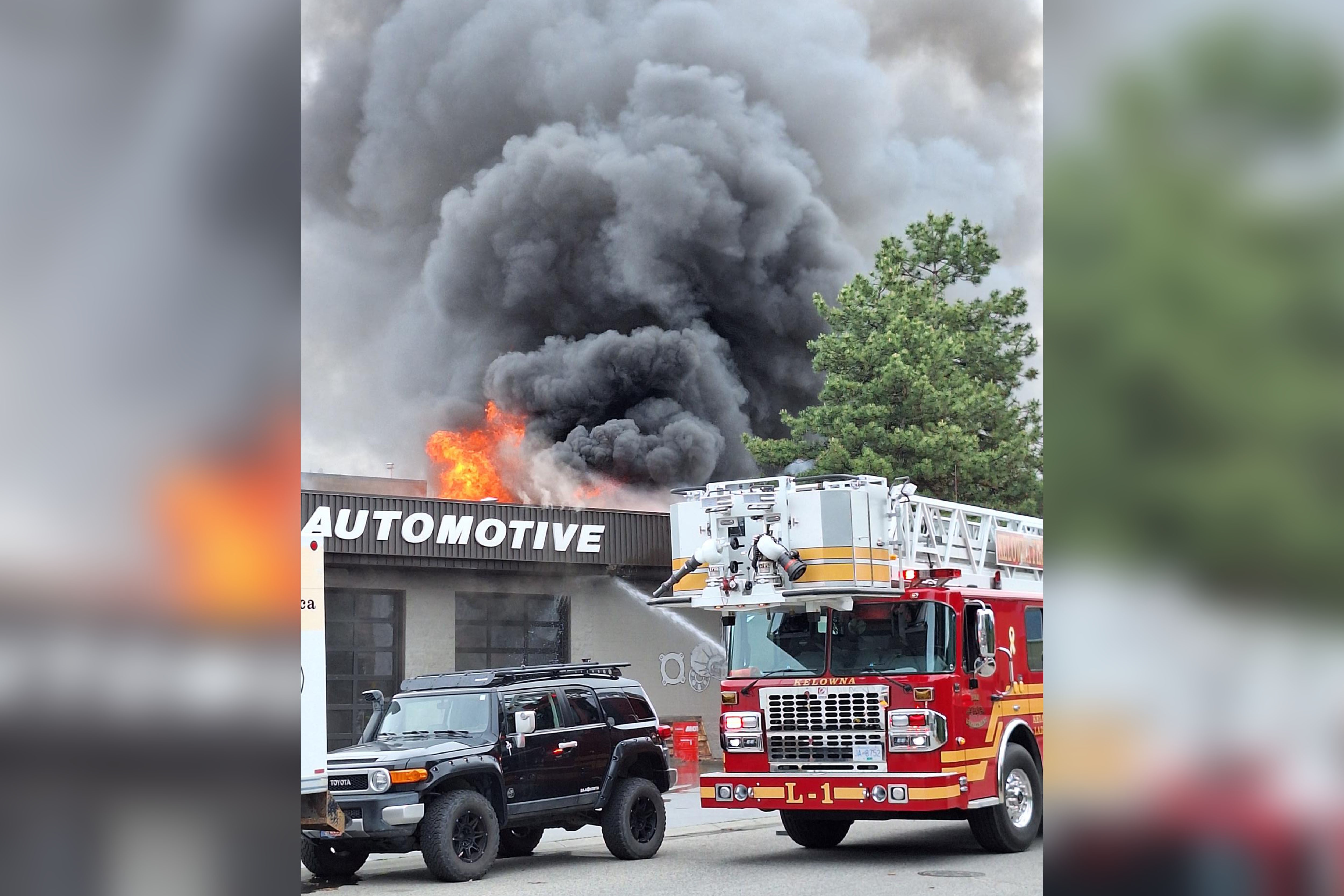 Kelowna firefighters battle blaze beside automotive shop