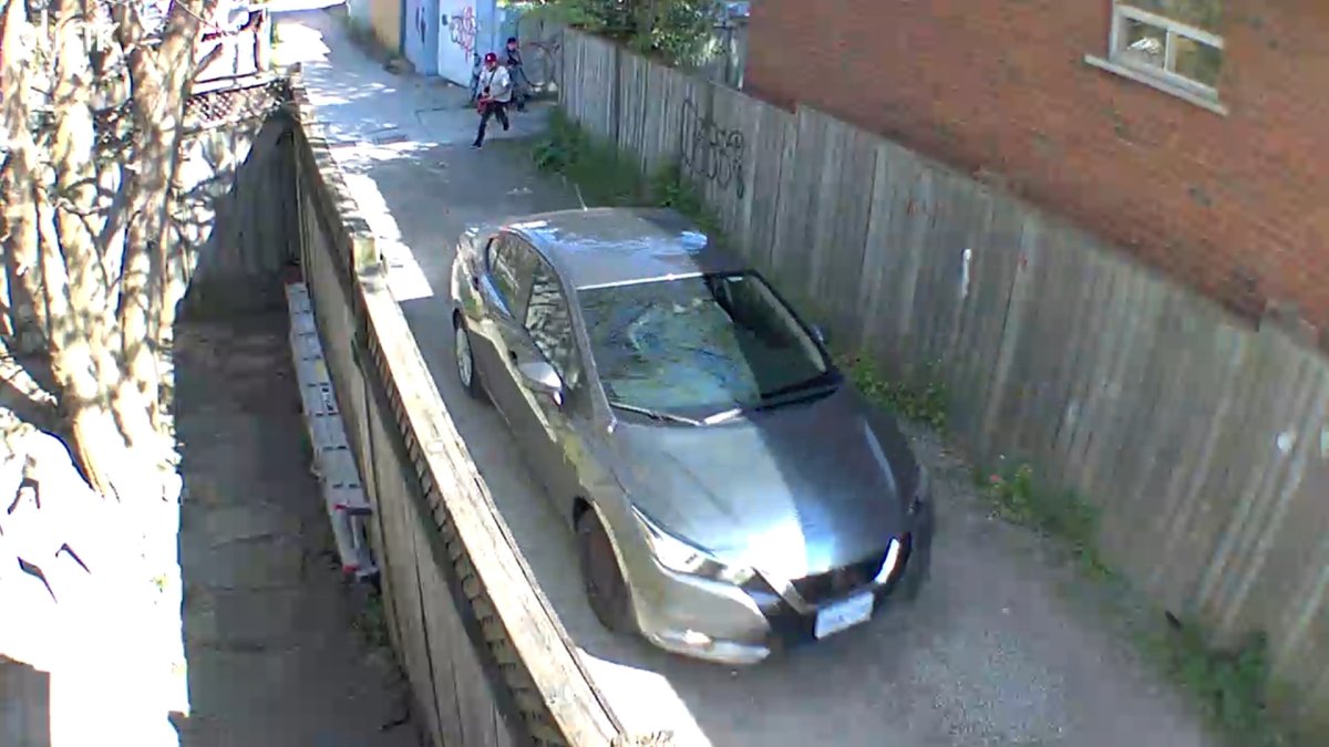 Surveillance footage from an alleyway in the area of Kinrade Avenue and Cannon Street East in Hamilton, Ont. on May 13, 2024.  Police have been seeking two suspects seen discharging a weapon at a Nissan. 