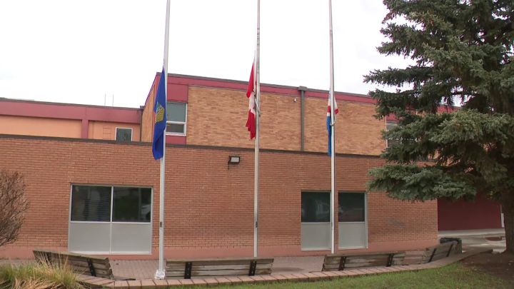 Flags are seen at half-staff on May 23, 2024 outside Lorne Akins Junior High School in St. Albert, Alta. A student at the school died earlier in the week.
