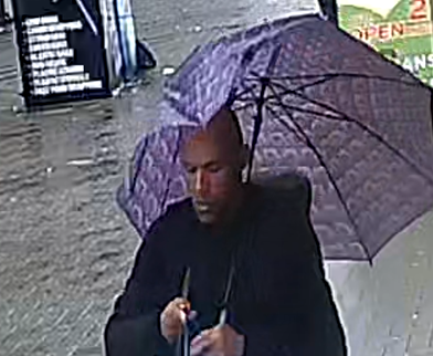 Police released a photo of the suspect carrying a purple umbrella, and said there had been an 'interaction' between him and the victim before the attack.