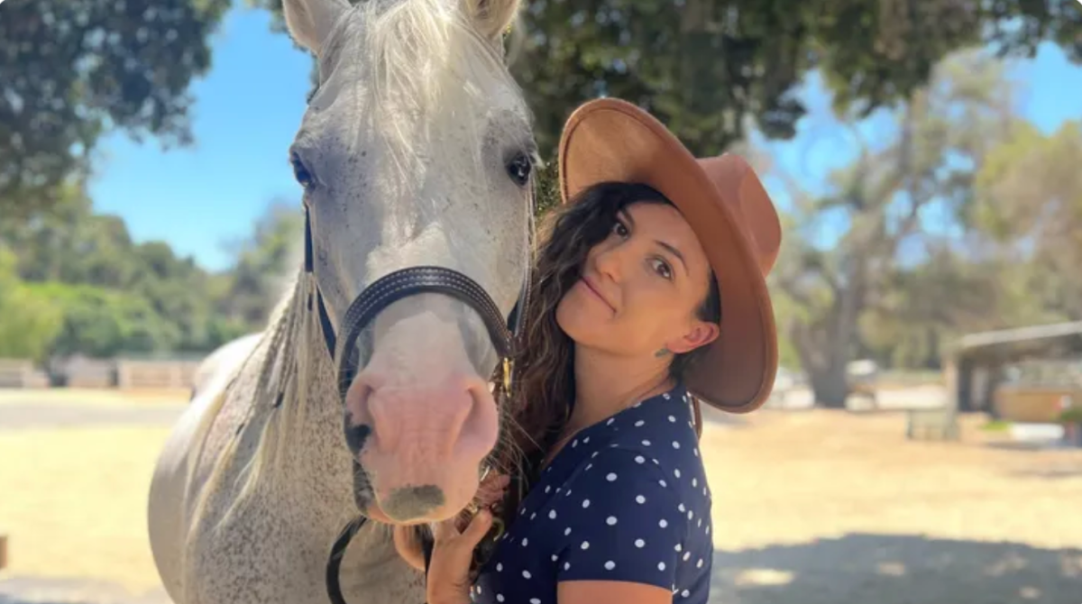 Photo of Allie Shehorn posing with a horse.