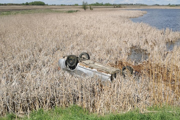 Killarney RCMP officers make save after vehicle flips in water-filled ditch