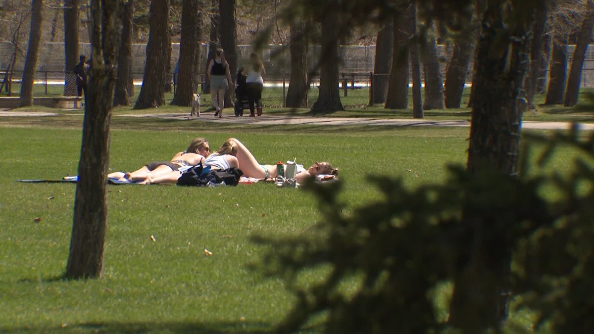 Sunbathers spotted in Calgary's Bowness Park as temperatures soared into the mid-20s on Friday and are forecast to stay warm through the Mother's Day weekend.