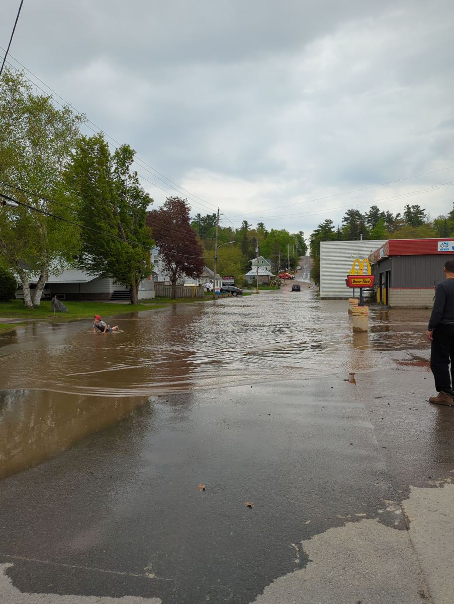 A child plays on a flooded road in Bancroft, Ont., on May 15, 2024.
