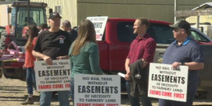 Dozens of farmers protest at grand opening of rail trail in Enderby to raise concerns over land access to their properties.
