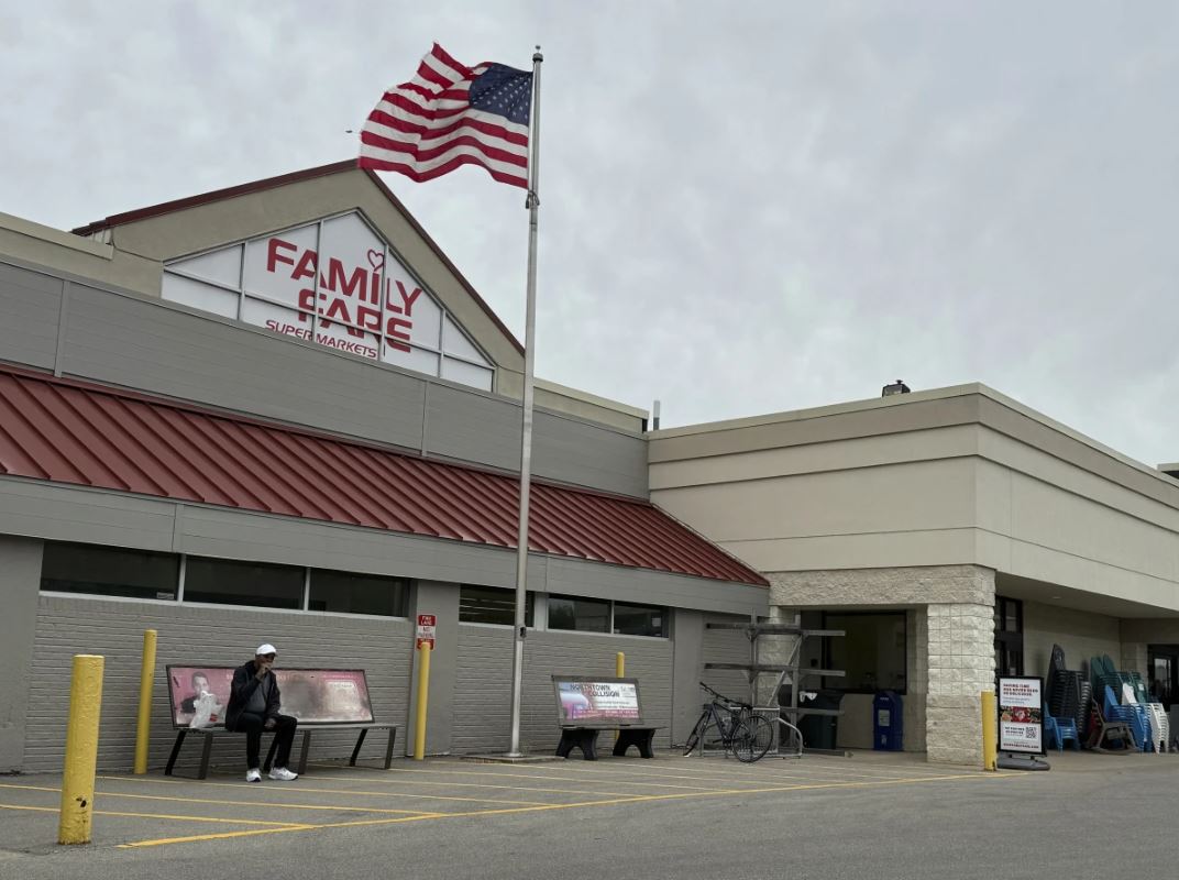 The woman was found living in the space behind the Family Fare grocery store sign in Midland, Mich.