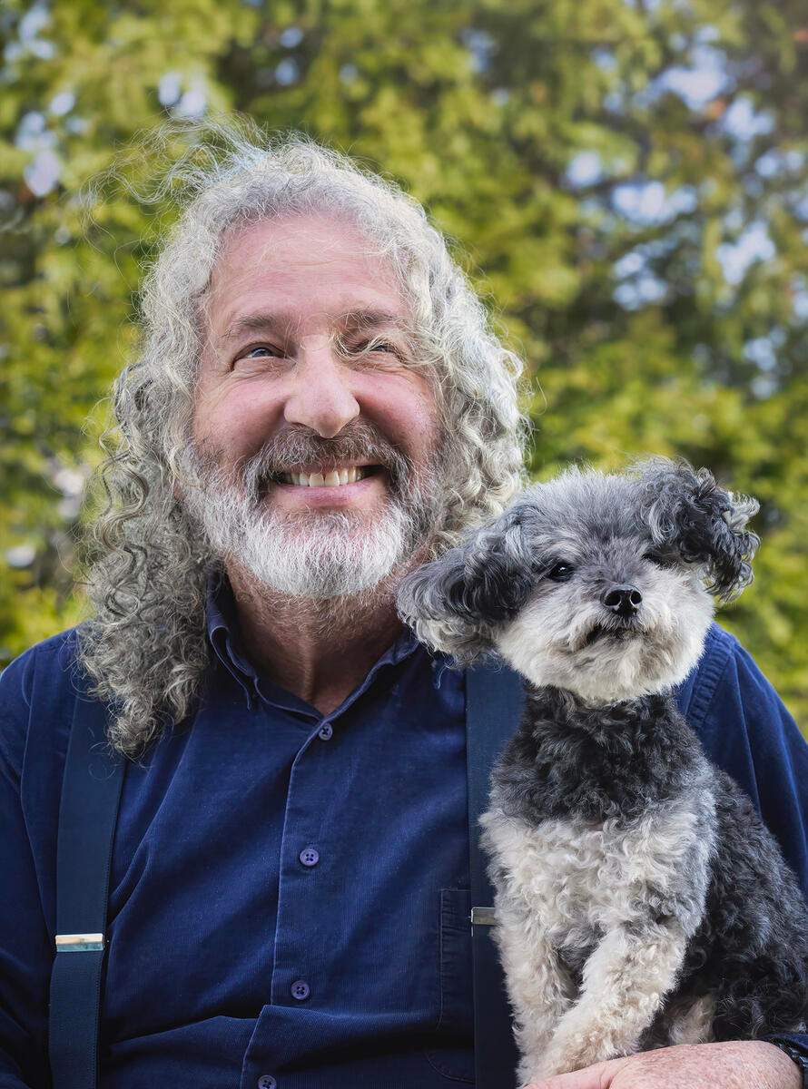 A man and his dog. They have similar hair.