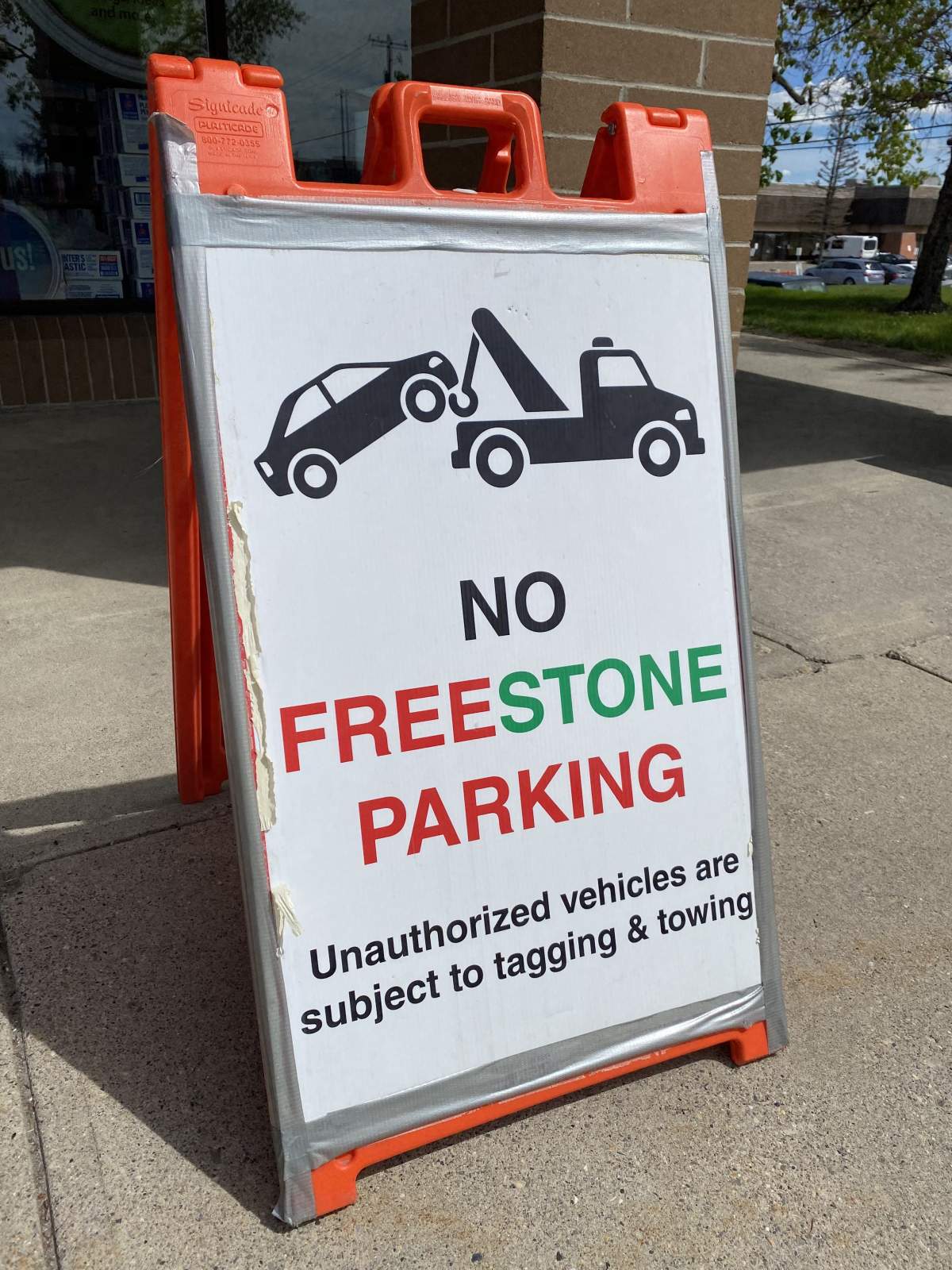 Sign in the parking lot of neighbouring plaza