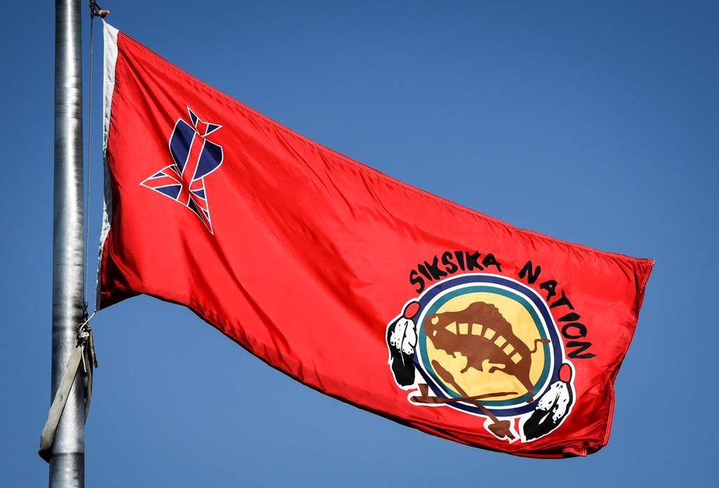The Siksika Nation flag flies in the breeze on the First Nation, near Cluny, Alta., Thursday, Sept. 28, 2023.