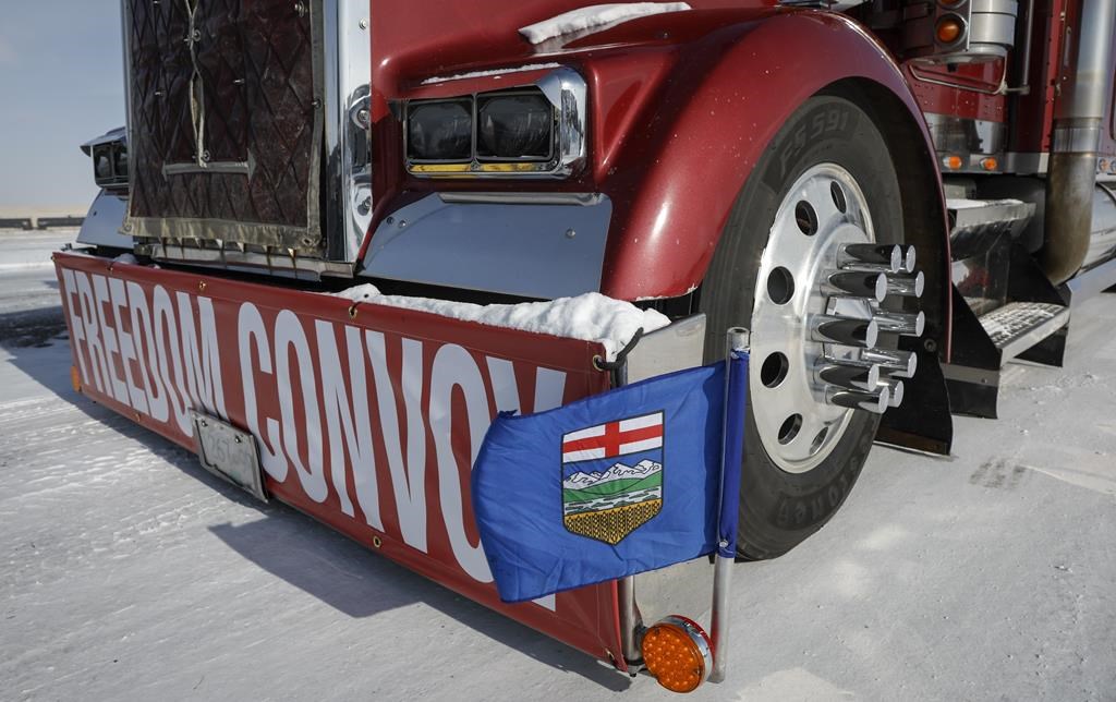 A truck convoy of anti-COVID-19 vaccine mandate demonstrators block the highway at the busy U.S. border crossing in Coutts, Alta., Wednesday, Feb. 2, 2022.