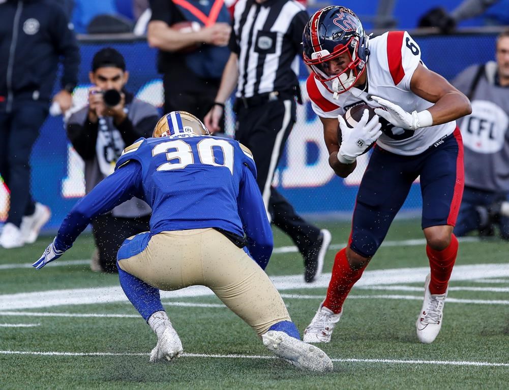 Montreal Alouettes' Tyson Philpot (6) dodges Winnipeg Blue Bombers' Tyrell Ford (30) to run the ball in for the touchdown during first half CFL action in Winnipeg Thursday, June 6, 2024.