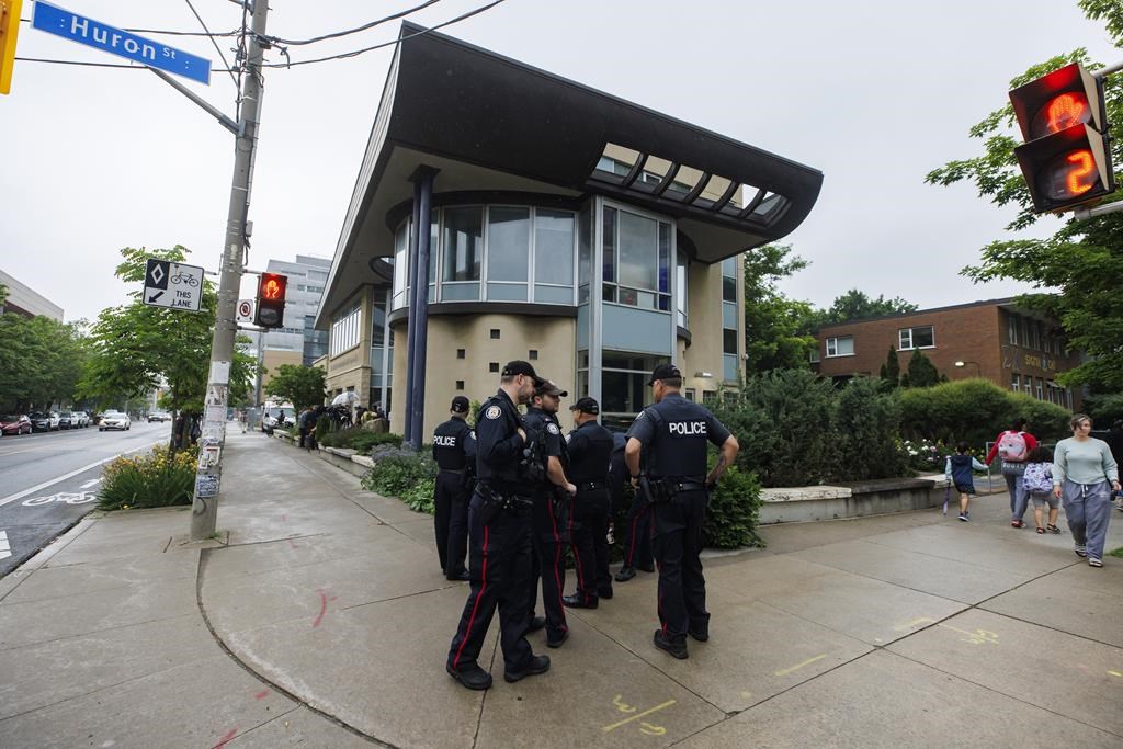 Toronto Police officers stand outside on the street near a press conference called by Canadian Jewish organizations in Toronto, June 3, 2024. 