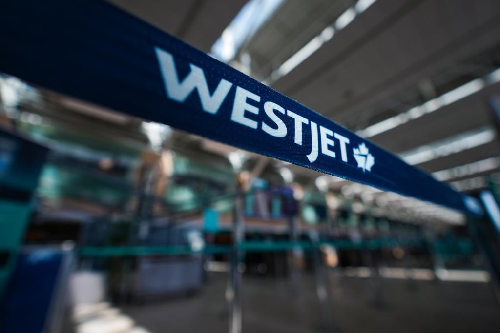 A WestJet logo is seen in the domestic check-in area at Vancouver International Airport, in Richmond, B.C., Friday, May 19, 2023.