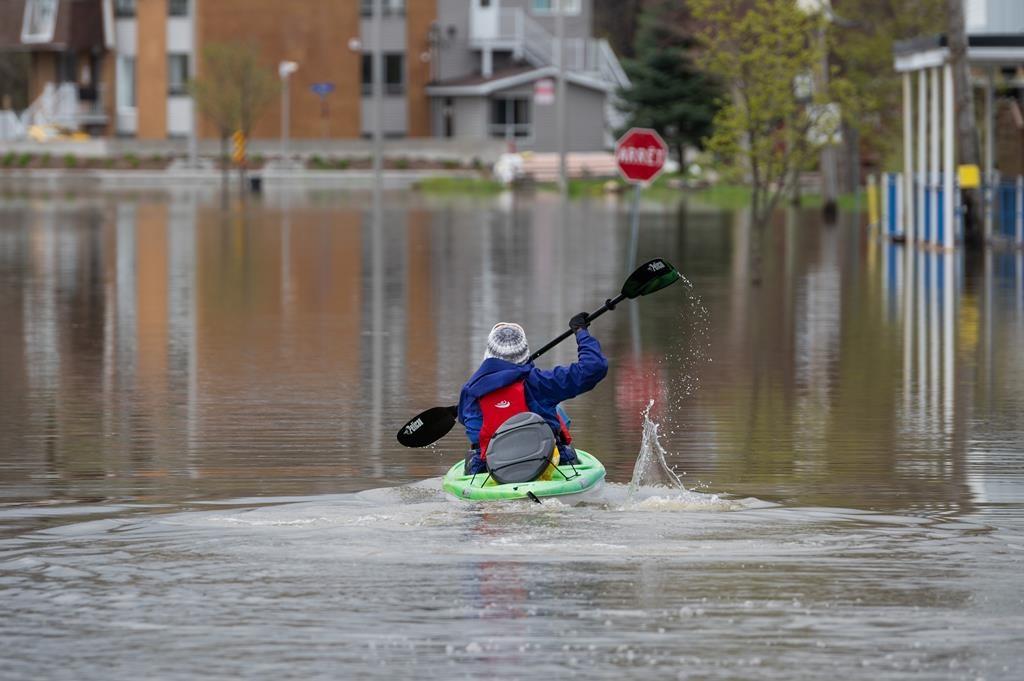 A resident uses a kayak to make their way through flooding in the Gatineau region of Quebec.