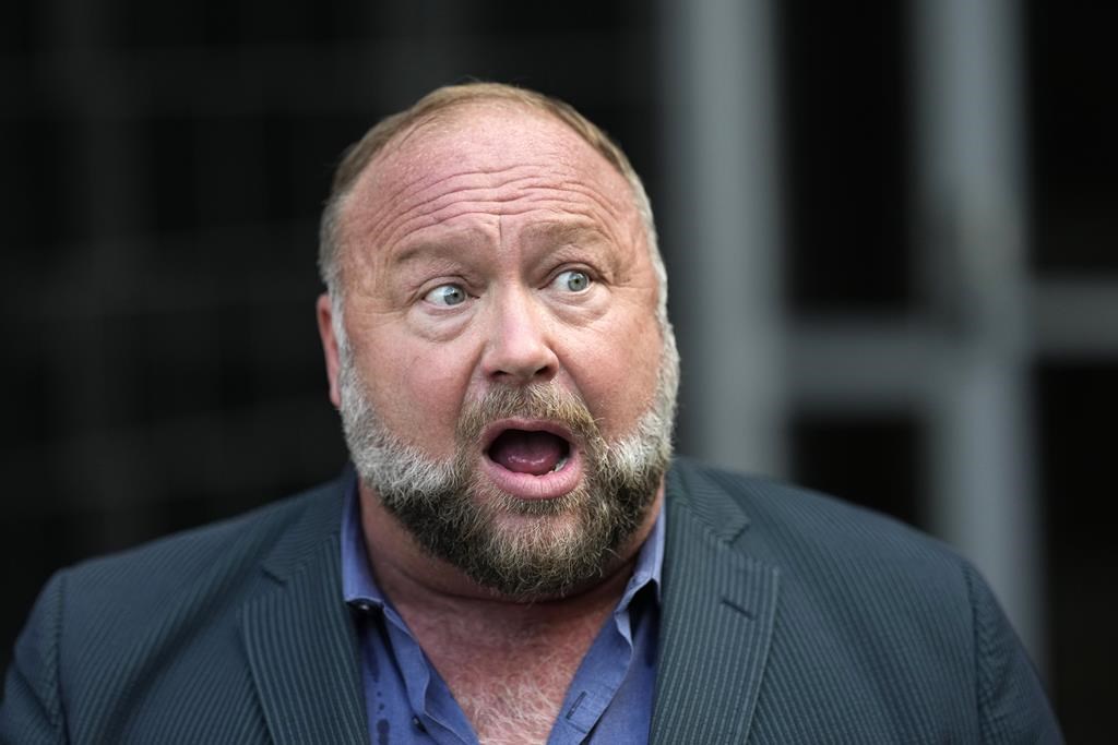 Right-wing conspiracy theorist Alex Jones speaks to the media after arriving at the federal courthouse for a hearing in front of a bankruptcy judge Friday, June 14, 2024, in Houston.