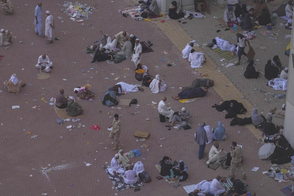 Muslim pilgrims rest after casting stones at pillars in the symbolic stoning of the devil, the last rite of the annual hajj, in Mina, near the holy city of Mecca, Saudi Arabia, Tuesday, June 18, 2024. Muslim pilgrims were wrapping up the Hajj pilgrimage in the deadly summer heat on Tuesday with the third day of the symbolic stoning of the devil, and the farewell circling around Kaaba in Mecca's Grand Mosque.