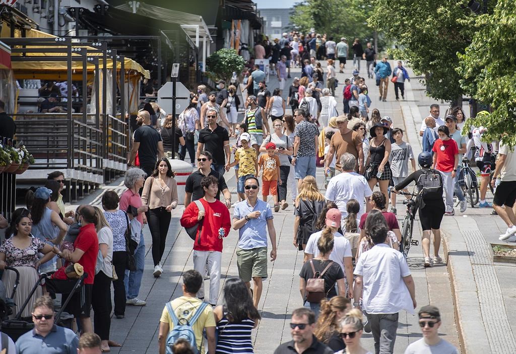 FILE - Pedestrians walk in Place Jacques-Cartier in Old Montreal on Sunday, July 4, 2021. THE CANADIAN PRESS/Graham Hughe.