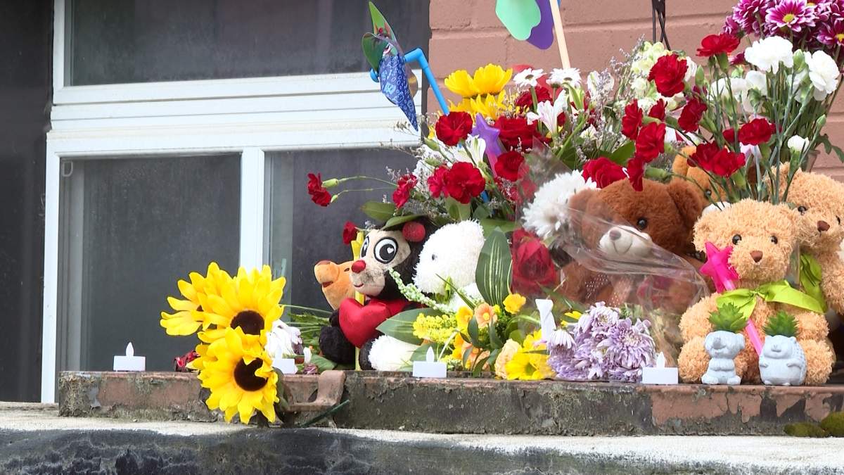 A mural sits outside the apartment building where Kingston police say an infant was found dead on May 31, after he and his brother were allegedly abandoned by their mother.