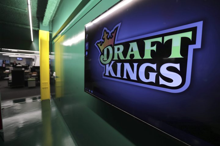 In this May 2, 2019, file photo, the DraftKings logo is displayed at the sports betting company headquarters in Boston.