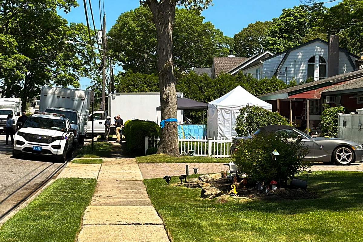 Suffolk County police stand outside the home of Rex Heuermann, Friday, May 24, 2024, in Massapequa Park, N.Y. Investigators continued to scour the home of the Manhattan architect charged in a string of slayings known as the Gilgo Beach killings. Friday marked the fifth straight day of the renewed search at Heuermann’s dilapidated, single-family home in Massapequa Park on Long Island. (AP Photo/Phil Marcelo)