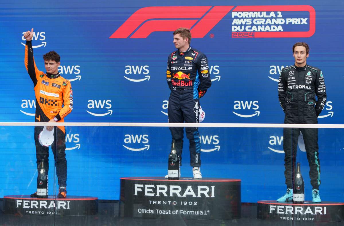 Winner Red Bull Racing driver Max Verstappen of the Netherlands stands on the podium next to second place McLaren driver Lando Norris, left, of the United Kingdom and third place Mercedes driver George Russell, right, of the United Kingdom at the Canadian Grand Prix Formula 1 car race, in Montreal, Sunday, June 9, 2024.