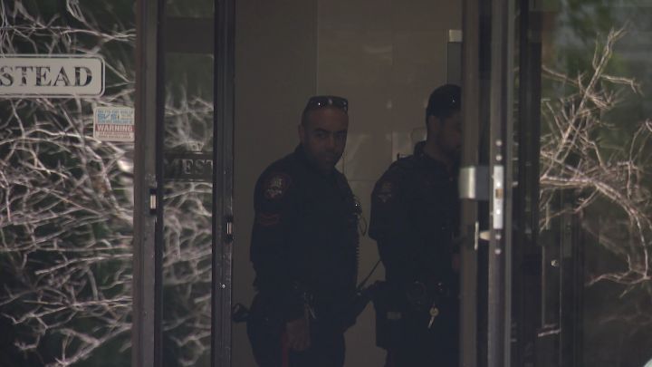 Calgary police officers investigate a stabbing at a southwest Calgary apartment building on June 17, 2024.