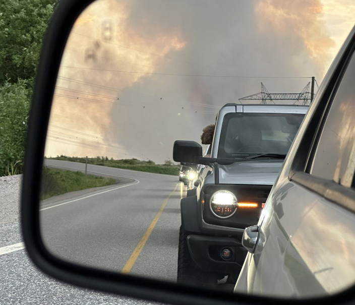 Vehicles leave Churchill Falls, N.L., under a threat of a wildfire in a Wednesday, June 19, 2024 handout photo.