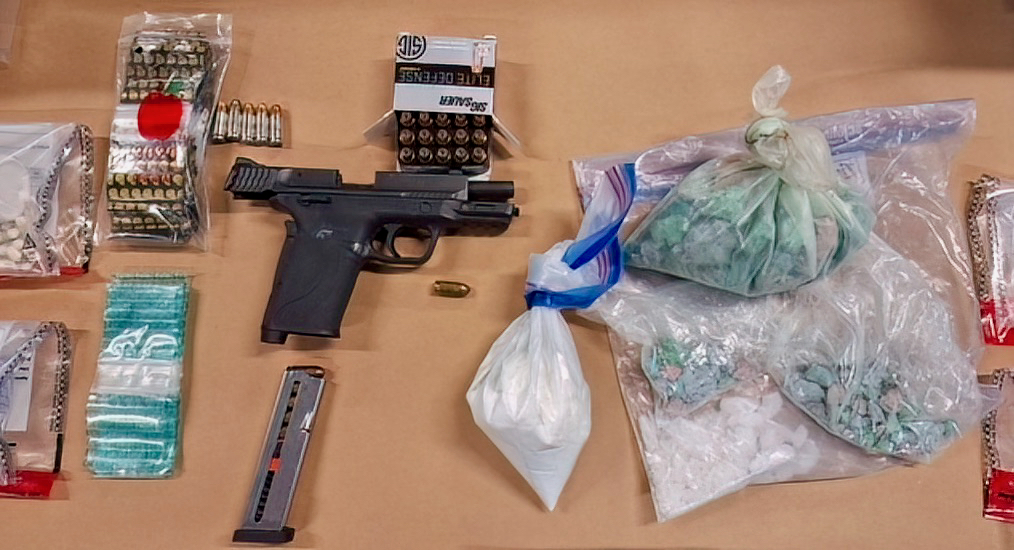 Police say $184,000 worth of drugs and a loaded handgun were seized at a home.