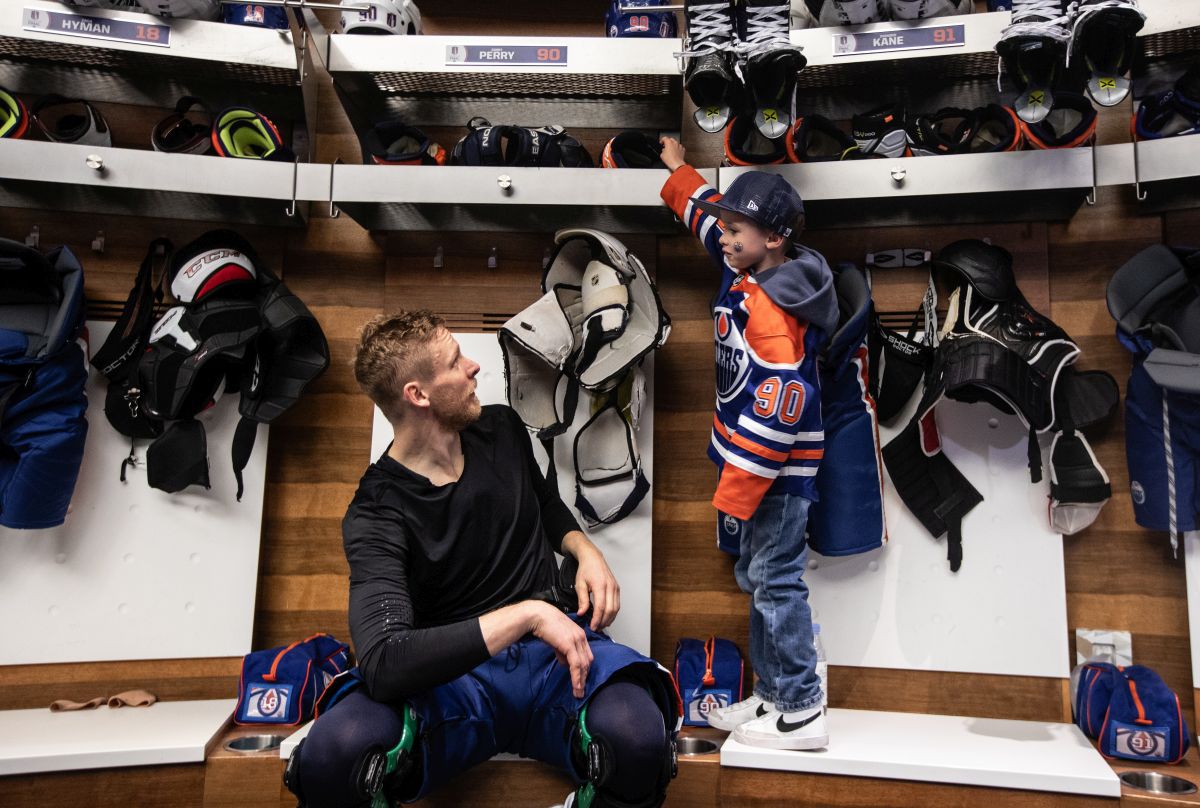 Edmonton Oilers' Corey Perry (90) and his son Griffin hang out together after practice in Edmonton on Friday June 14, 2024.