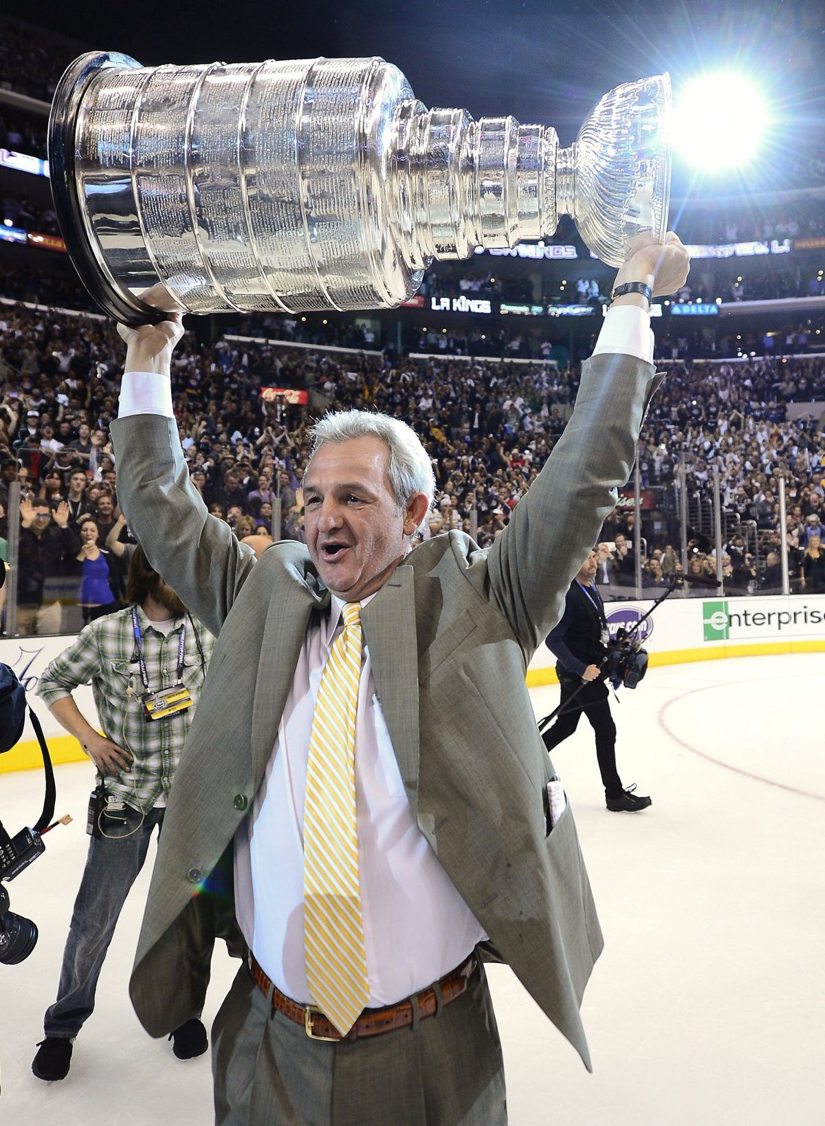 Los Angeles Kings coach Darryl Sutter hoists the Stanley Cup after beating the New Jersey Devils 6-1 during Game 6 of the NHL hockey Stanley Cup finals, Monday, June 11, 2012, in Los Angeles.