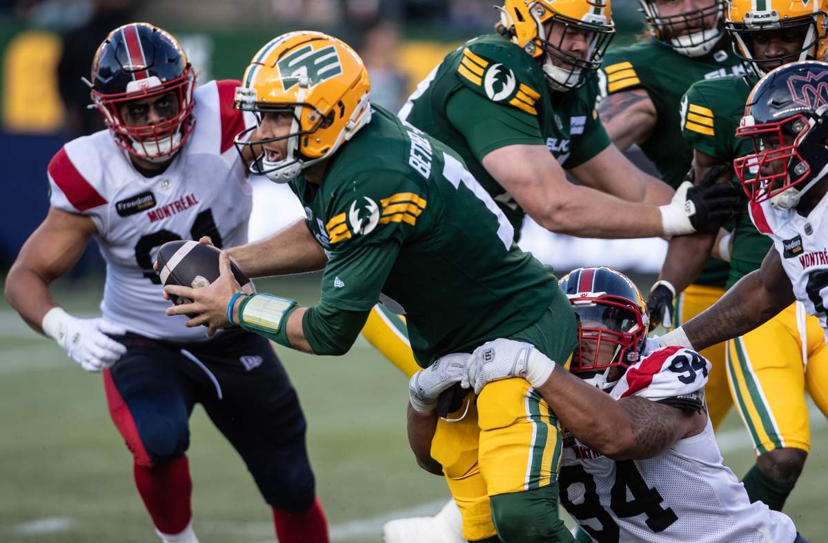 Montreal Alouettes' Mustafa Johnson (94) tackles Edmonton Elks quarterback McLeod Bethel-Thompson (10) during second half CFL action in Edmonton, Alta., on Friday June 14, 2024.