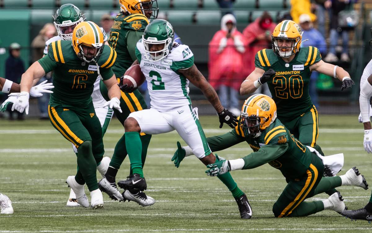 Saskatchewan Roughriders' Bryan Cox Jr. (50) chases Edmonton Elks' Kevin Brown (4) during first half CFL action in Edmonton, Alta., on Saturday June 8, 2024.