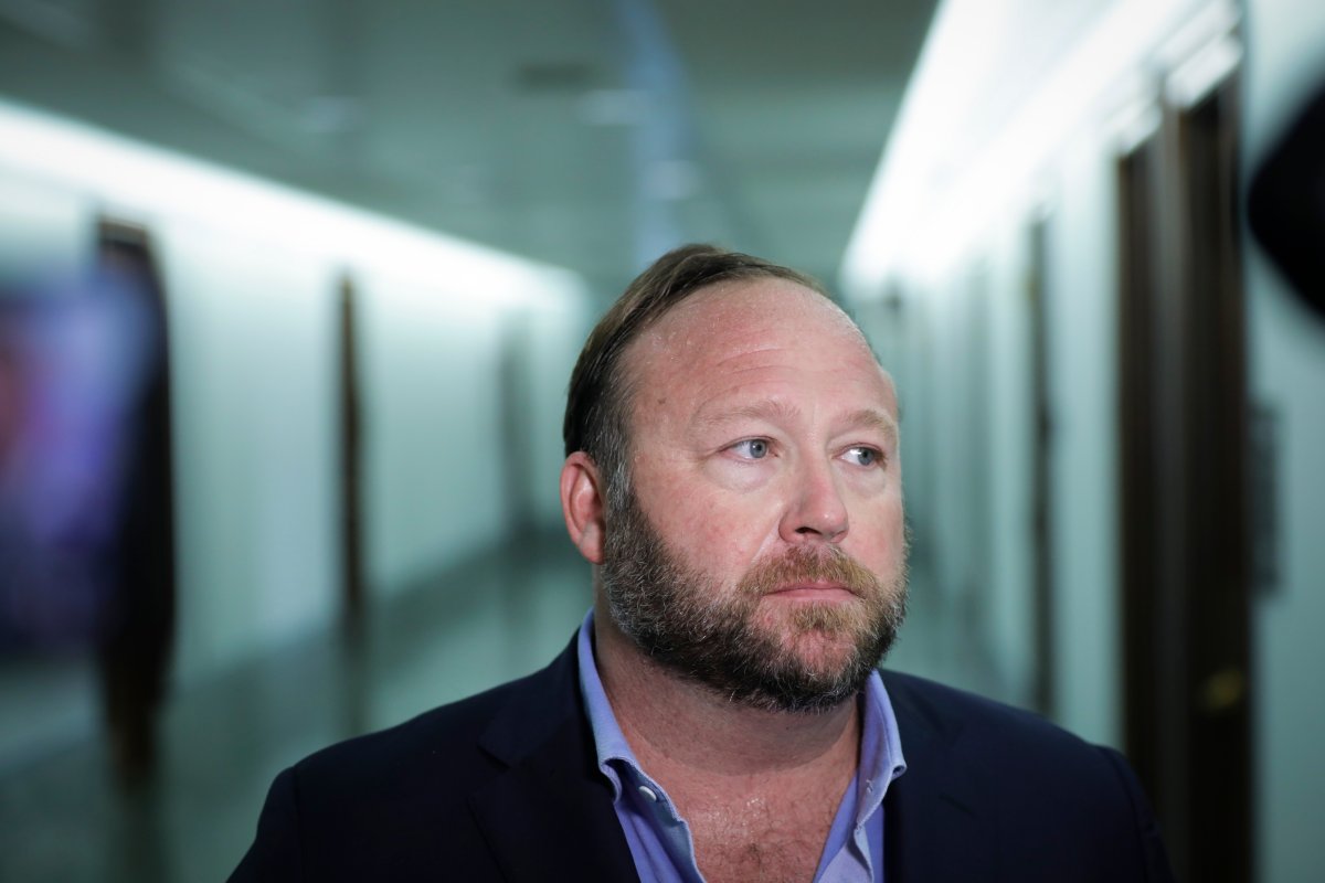 Alex Jones talks to reporters outside a Senate Intelligence Committee hearing concerning foreign influence operations' use of social media platforms, on Capitol Hill, September 5, 2018 in Washington, DC. Jones asked a U.S. judge to convert his bankruptcy into a Chapter 11 liquidation to help pay off his legal debts owed to the families of Sandy Hook victims.