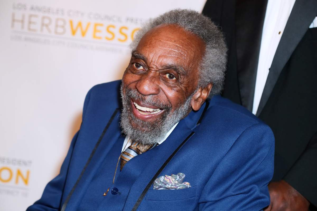 Bill Cobbs in a blue suit.