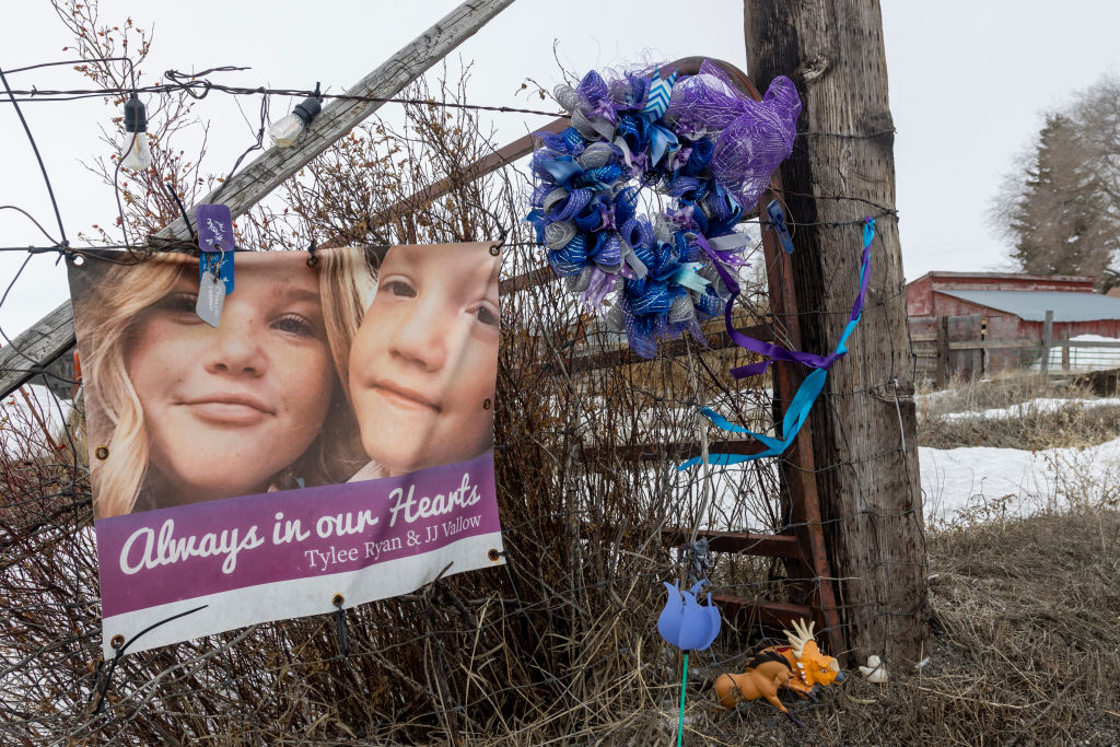 A picture of Tylee Ryan (L) and J.J. Vallow is seen on a fence opposite the property where their bodies were found in 2020, on April 4, 2023 in Rexburg, Idaho.