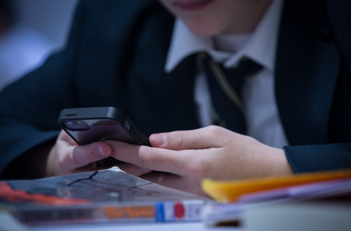 File photo of a student using his cell phone at school on February 26, 2015.